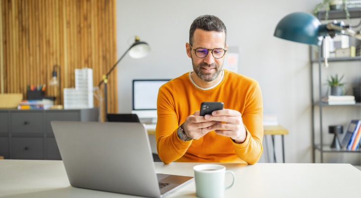A man looking up the federal corporate tax rate. 